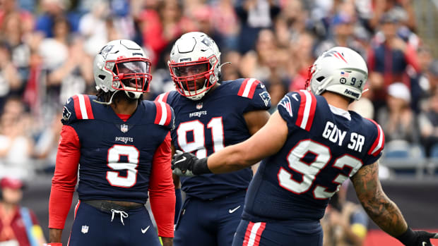 Nov 6, 2022; Foxborough, Massachusetts, USA; New England Patriots linebacker Matthew Judon (9), defensive end Deatrich Wise Jr. (91), and defensive end Lawrence Guy (93) react after sacking Indianapolis Colts quarterback Sam Ehlinger (not seen) during the first half at Gillette Stadium.